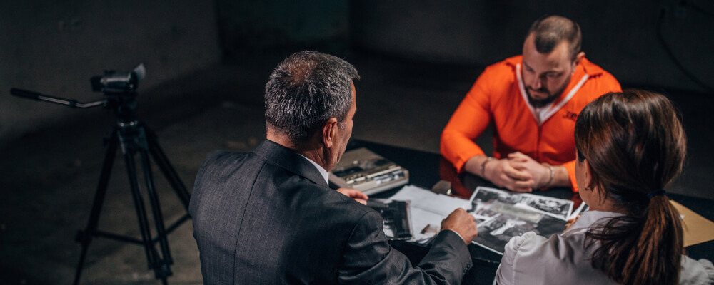 interrogators speaking with a prisoner