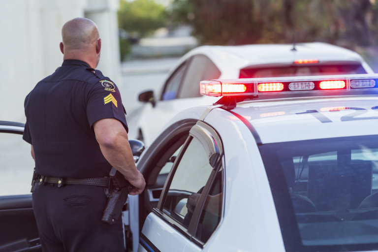 Police officer pulling over civilian without reasonable cause.