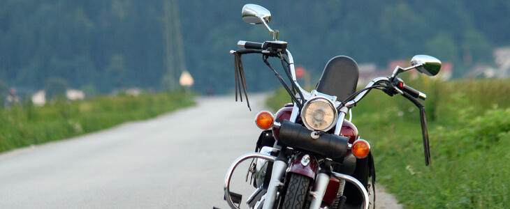 closeup picture of a motorcycle by the side of a road