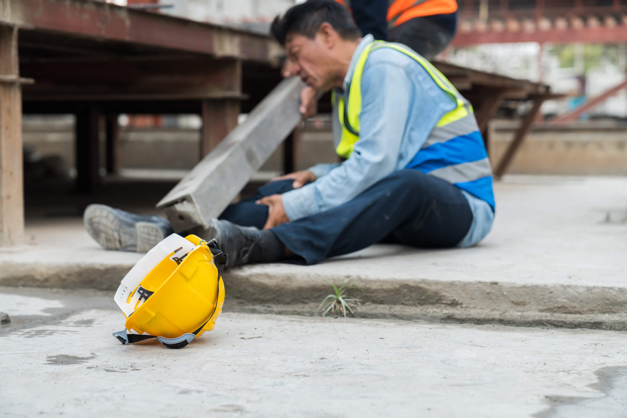 Asian male worker accident at his leg at construction site. Industrial accident concept